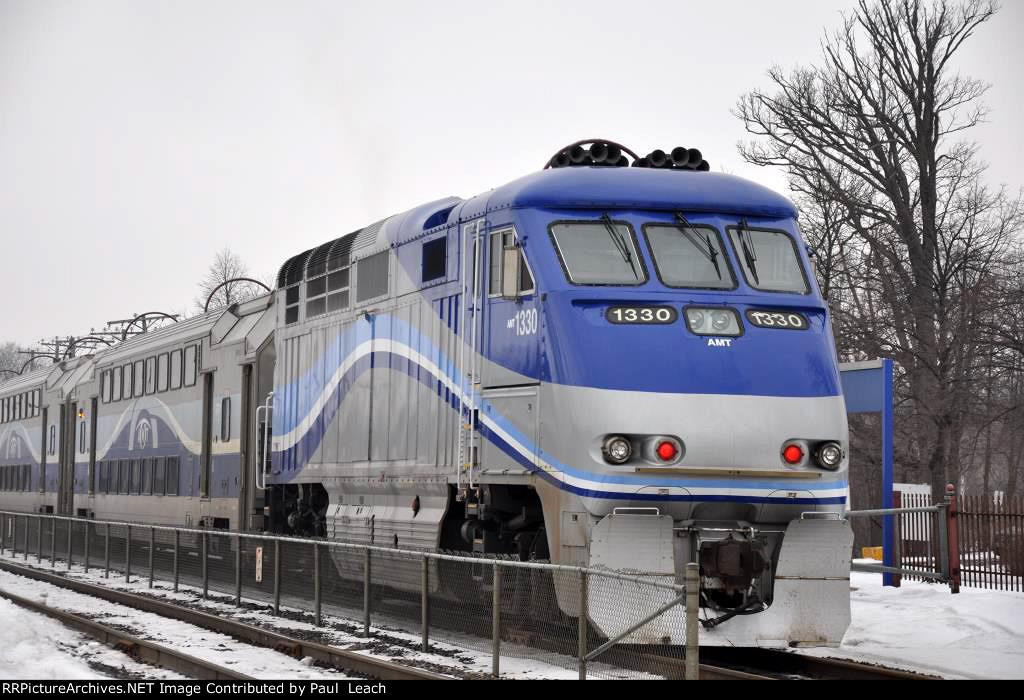 Commuter train shoves west out of the station